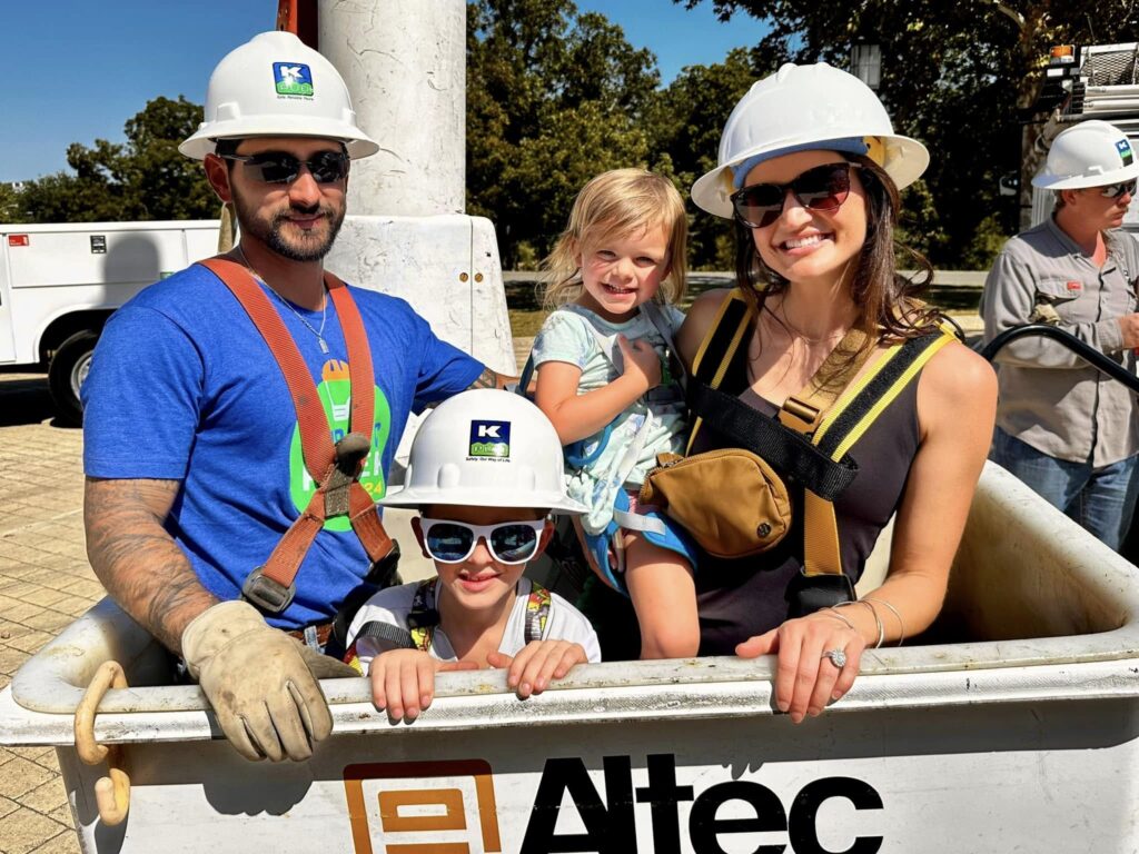 Photo cutline: KPUB lineman Michael Martinez gives Reno family participants a bucket truck ride during Public Power Week 2024