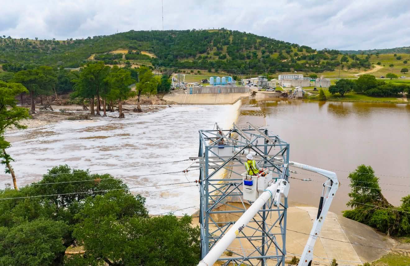 Photo cutline 2: KPUB crews and mutual aid line workers from James Power Line Construction work together on Friday, July 17, to repair the river crossing power lines serving the City of Kerrville's wastewater treatment plant after a barge and crane involved in the Nimitz Lake recovery operation damaged the crossing.