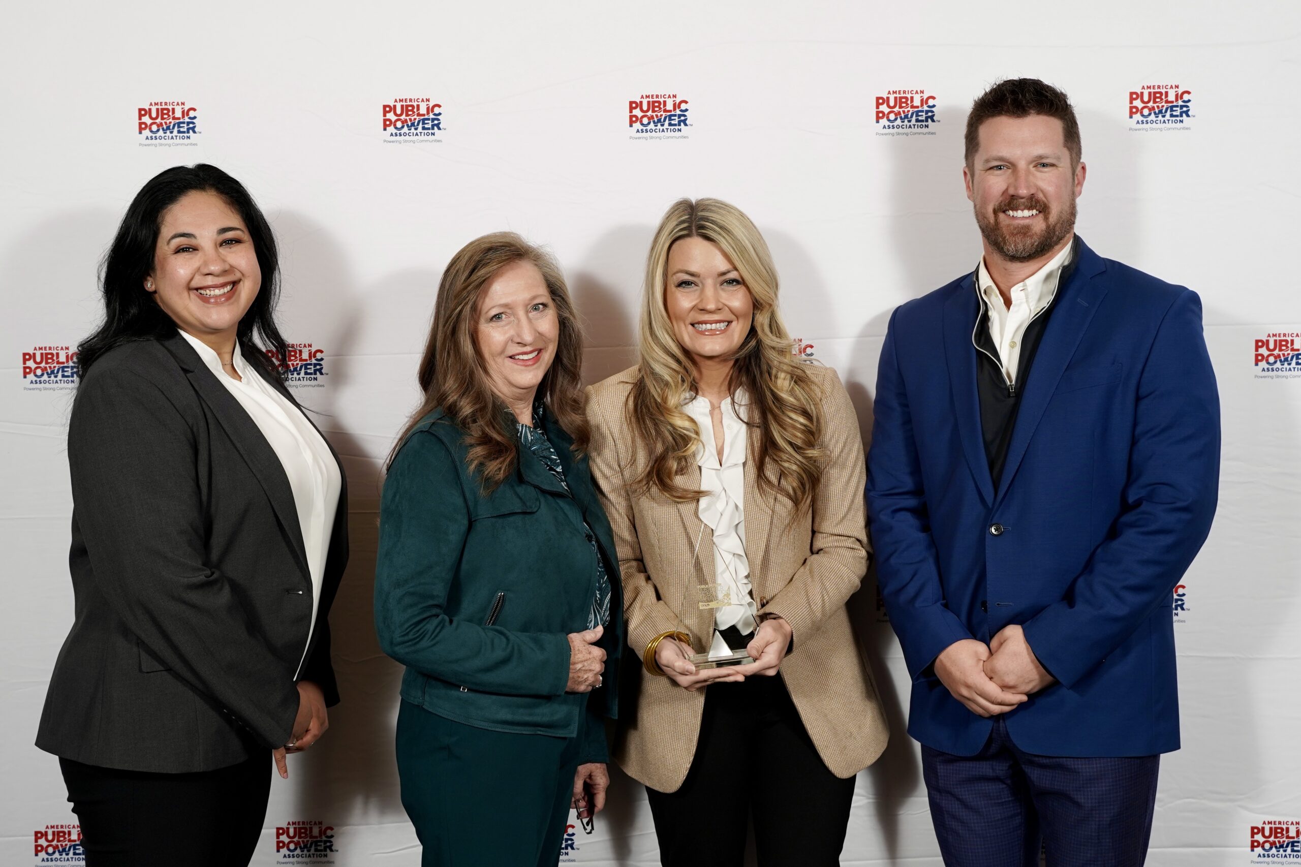 KPUB employees proudly display the utility’s first Gold Public Power Customer Satisfaction Award at the American Public Power Association (APPA) Customer Connections Conference on Tuesday, October 27, 2026. Pictured from left are Asha Ramirez, KPUB CSR Lead; Jo Anderson, KPUB Supervisor of Customer Service; Allison Bueche, KPUB Director of Customer & Community Relations; and DJ Owens, KPUB Energy Services Manager.